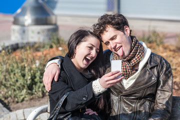 Young Couple Using Mobile Phone