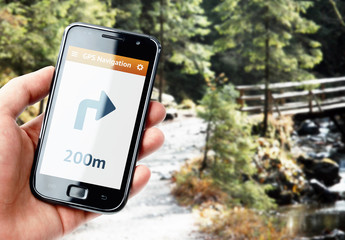 Hand holding smartphone with gps navigation