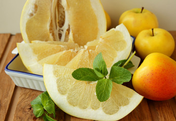 Slice of Pomelo, a sprig of mint and apples