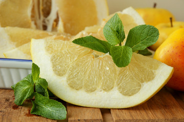 Slice of Pomelo, a sprig of mint and apples
