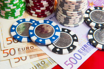 Poker chips stack with euro bills