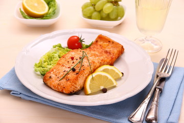 Grilled salmon filet, vegetables, grapes and wine
