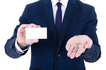 close up of key and visiting card in male real estate agent hand