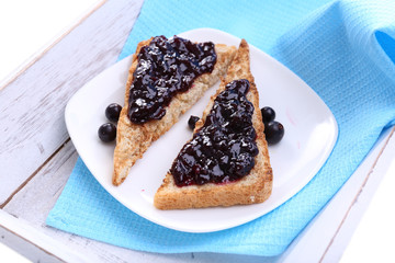 Delicious toast with jam on plate close-up