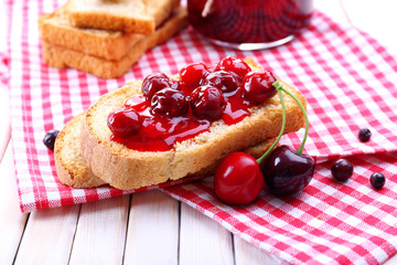 Delicious toast with jam on table close-up