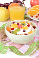 Delicious oatmeal with fruit in bowl on table close-up