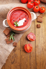 Tasty tomato soup on wooden table