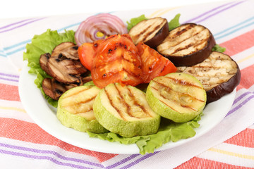 Delicious grilled vegetables on plate on table close-up