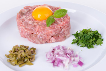 Fototapeta premium Delicious steak tartare with yolk on plate close-up