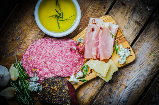 Chopping board of Assorted Cured Meats, Cheese and Honey with ro