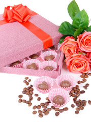 Delicious chocolates in box with flowers close-up