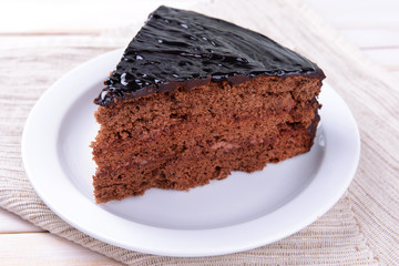 Delicious chocolate cake on plate on table close-up