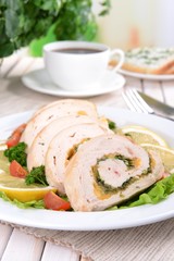 Delicious chicken roll on plate on table close-up