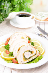Delicious chicken roll on plate on table close-up