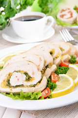 Delicious chicken roll on plate on table close-up