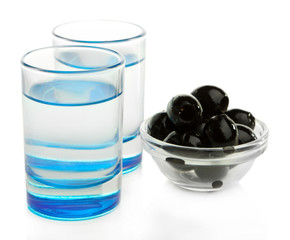 Composition with  two glasses  of vodka, and black olives,
