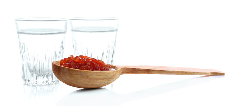 Glasses of vodka, red caviar  isolated on white