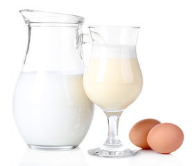 Eggnog with milk and eggs isolated on white