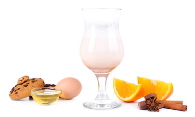 Eggnog with spices and orange isolated on white