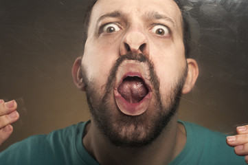 Funny Faces - Man Blowing Against the Glass Surface