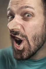 Fototapeta premium Funny Faces - Man Blowing Against the Glass Surface