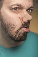 Obraz premium Funny Faces - Man Blowing Against the Glass Surface