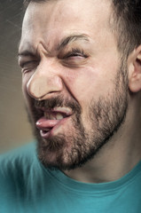 Obraz premium Funny Faces - Man Blowing Against the Glass Surface