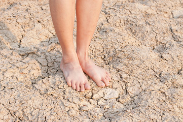 naked Feet on dry Soil