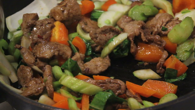 pork stir fry cooking in wok