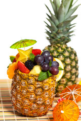 Salad of pineapple, oranges and other fruits in a pineapple