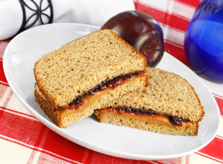 Healthy lunch of Peanut Butter and Jelly Sandwich on Whole Wheat