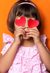 Little girl and red hearts.