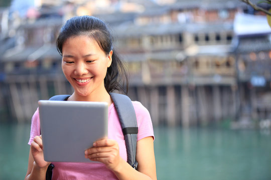woman tourist use digital tablet at fenghuang ancient town,china