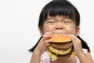 Kid eating big burger