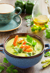 Cream of asparagus soup with shrimp.
