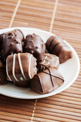 chocolate pralines on old wooden table