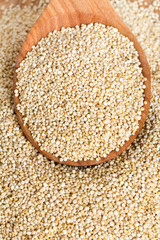 white quinoa on wooden background