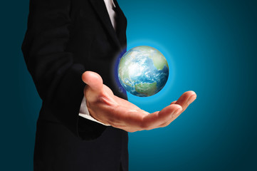 Businessman holds Earth in a hand