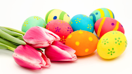 Colorful easter eggs and flowers isolated on a white