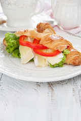 Fresh croissants with cheese on a table