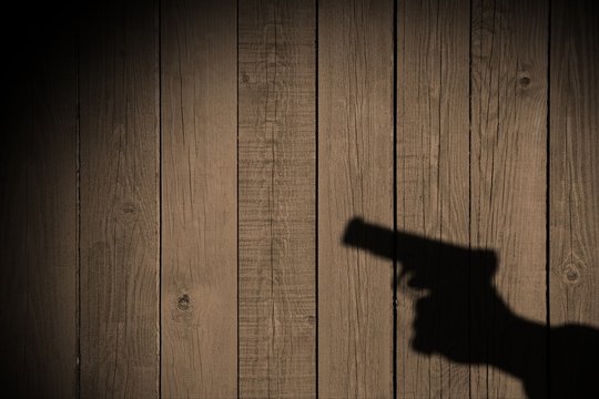 Hand with a gun on a wooden fence, XXXL image