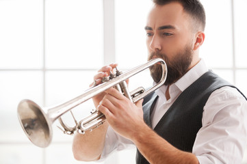 Improvising with his trumpet.