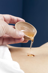 ayurveda oil pouring on belly for wellbeing