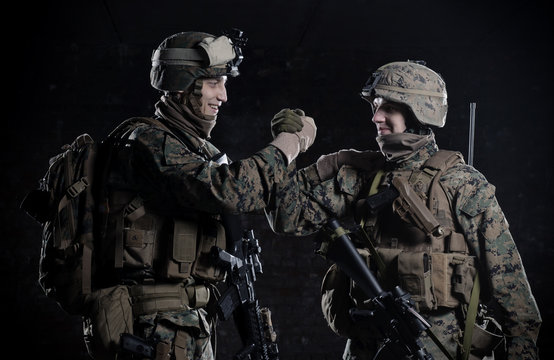 U.S. military marines congratulate each other. High five.