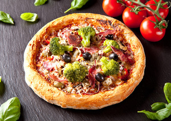 Fresh italian pizza served on black stone