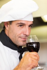 Closeup of a male chef smelling red wine