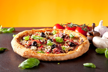 Fresh italian pizza served on black stone