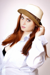 Beautiful red hair woman wearing hat