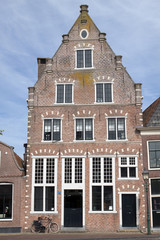 Fototapeta na wymiar Single old house on the habour of the Dutch historic town Hoorn.