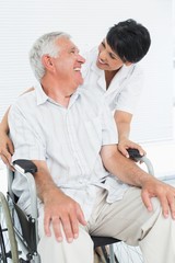 Fototapeta premium Portrait of a nurse with senior patient sitting in wheelchair